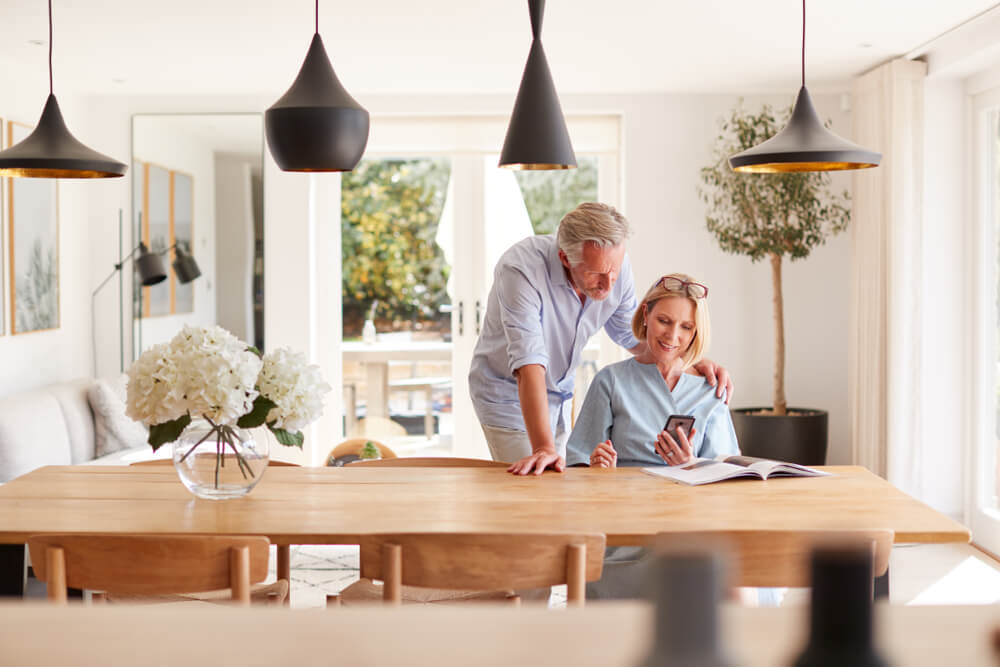 Couple Relaxing At Dining Room Table 